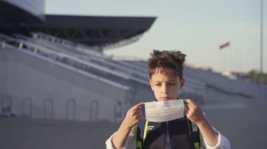 Beyaz okul çocuğu yüz maskesi takıyor. Covid-19 salgınında ders çalışıyordu. Okul konseptine dönelim.