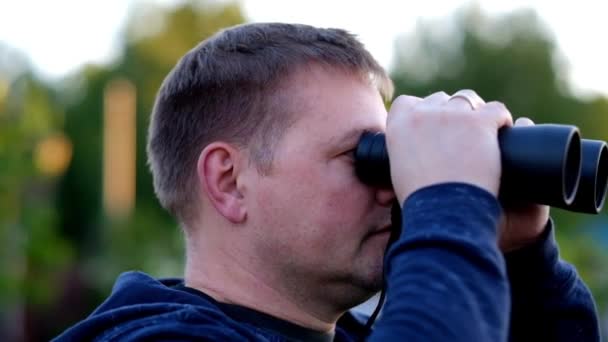 Joven viajero hombre sosteniendo prismáticos — Vídeos de Stock