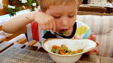 Oğlan makarna yiyor. Doğru beslenme. Aç bir çocuk.