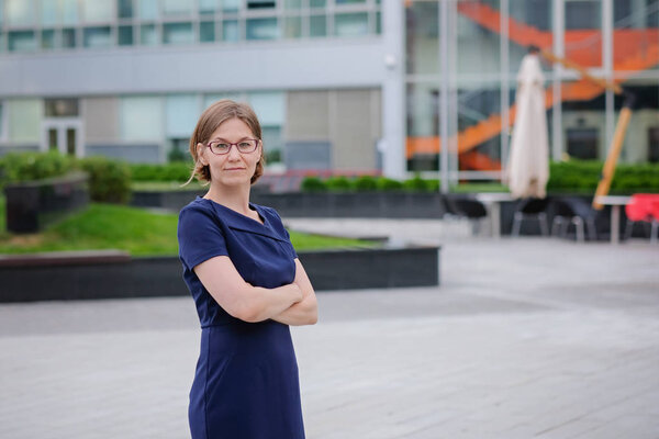 Young confident businesswoman at the office, smiling