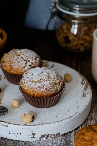 Homemade muffins decorated with sugar powder, hazel nuts — Stock Photo, Image