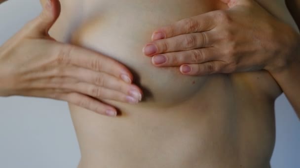 Frau untersucht ihre Brust. Brustkrebs-Aufklärungskonzept.