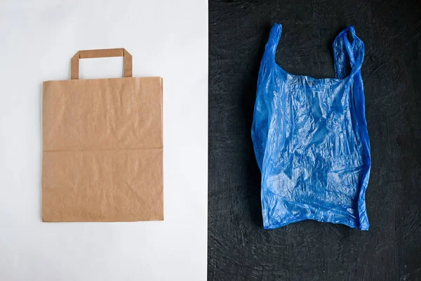Plastic free concept. Paper bag and plastic bag on white and black background. Flat lay