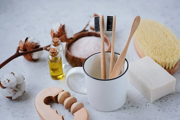 Plastic free products and bamboo toothbrush - creative layout on grey background. Eco natural skin care concept.