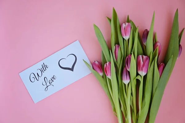 Styled feminine flatlay with pink tulip flowers and card WITH LOVE — Stock Photo, Image