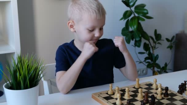 Um rapazinho a jogar xadrez com o pai. Conceito de educação e família — Vídeo de Stock