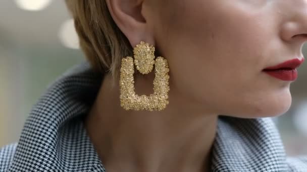 Close up of beautiful female earrings, while a woman turning her head — Stock Video