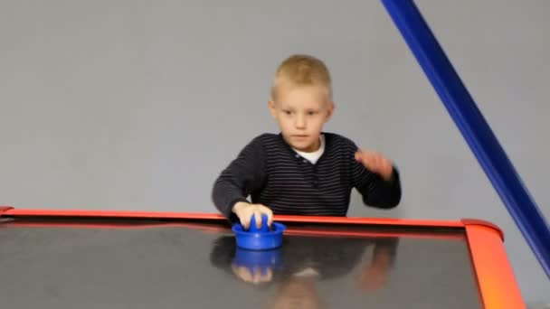 Happy boy playing air hockey , close up — Stock Video