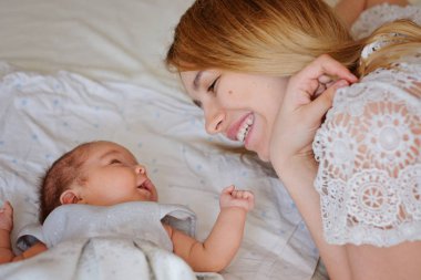 Young beautiful mother with her newborn baby girl