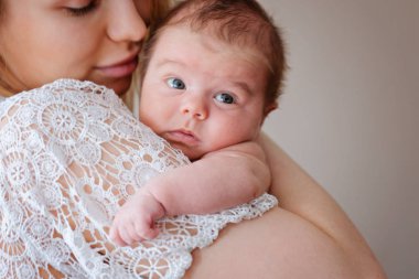 Young beautiful mother with her newborn baby girl