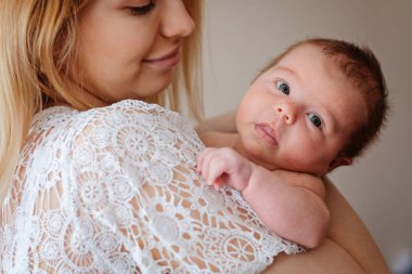 Young beautiful mother with her newborn baby girl