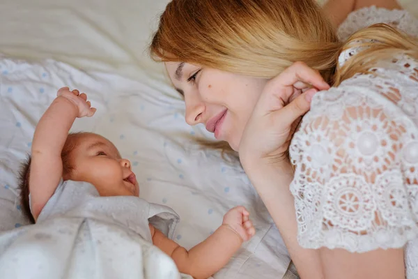 Young beautiful mother with her newborn baby girl