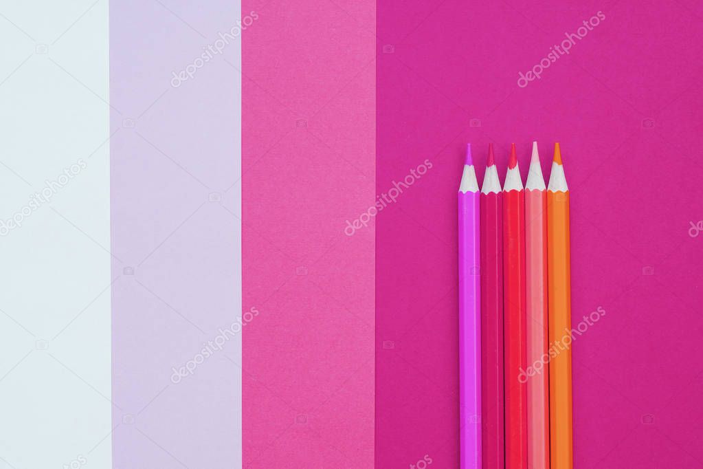 Abstract geometric paper background with color pencils. Pink and coral trendy colors. School and education concept.