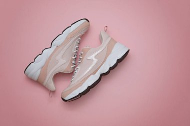 Markasız modern sportif ayakkabılar, pembe arka plan üzerinde spor ayakkabılar. Üstte görüntü.