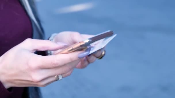 Woman paying with her credit card and smartphone, close up — Stock Video