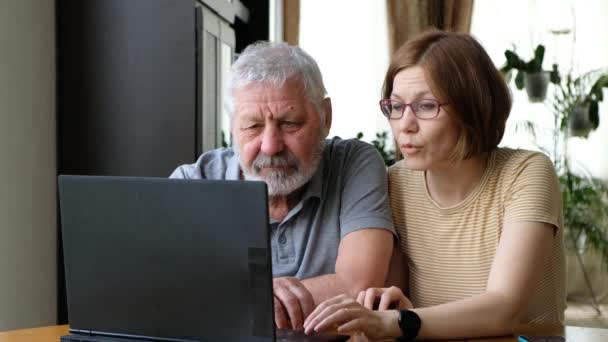 Glad äldre far farfar och vuxen dotter, hjälpa honom med datorn — Stockvideo