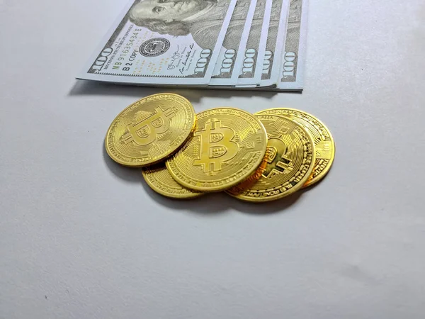 bitcoins with dollars on a wooden background