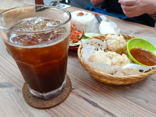 a set menu of meals and snacks: smashed chicken, cireng, and sweet iced tea