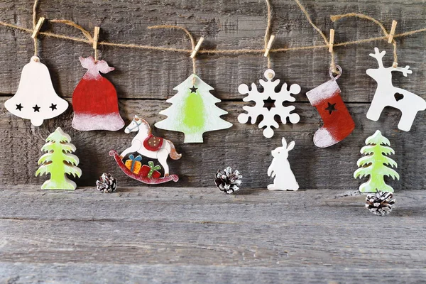 Bright Christmas and New Year decorations made of wood on the wooden background.