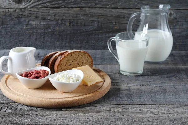 Breakfast on the table. Composition of dairy products on a wooden background.