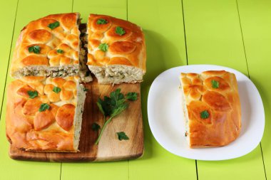 Taze pişmiş balık pasta üzerinde yeşil bir ahşap masa.