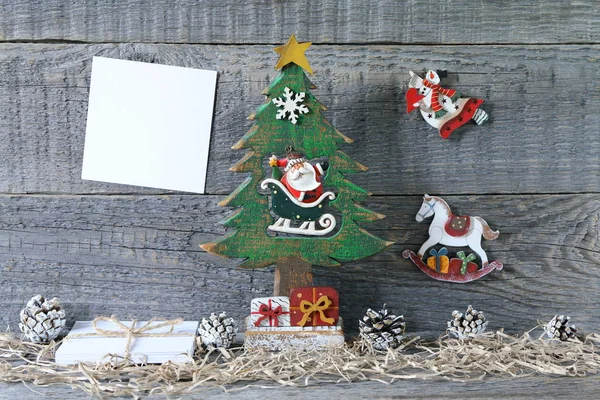 Composition of Christmas and New Year bright decorations made of plywood is on a gray wooden background.