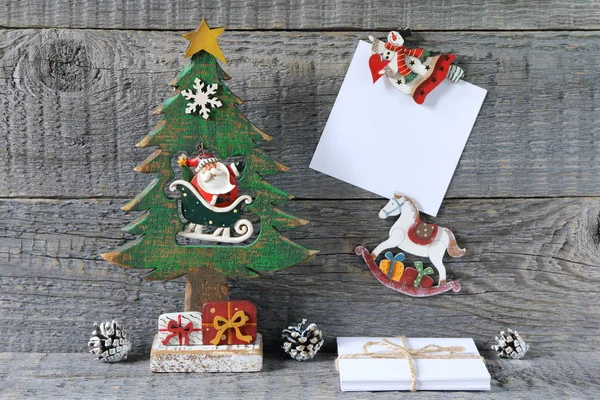 Composition of Christmas and New Year bright decorations made of plywood is on a gray wooden background.