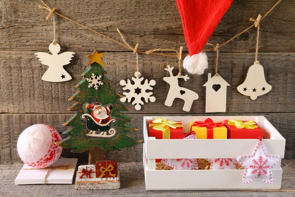Bright Christmas and New Year decorations made of plywood and fabric is on a gray wooden background.