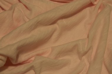 Bu, Açık Pembe kumaş arka planının yakın plan fotoğrafı.