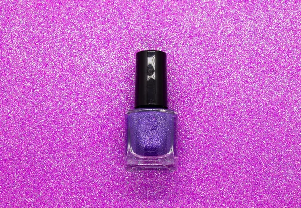 Purple nail polish on a glittery background