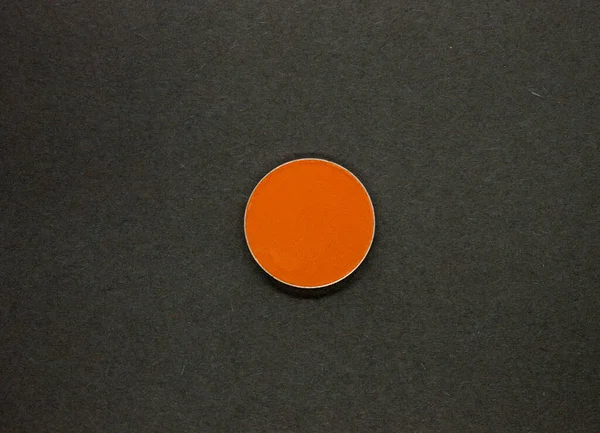 Neon Orange Eyeshadow isolated on a Black background