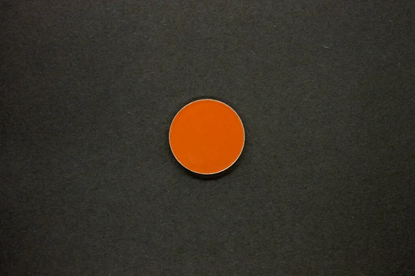 Neon Orange Eyeshadow isolated on a Black background