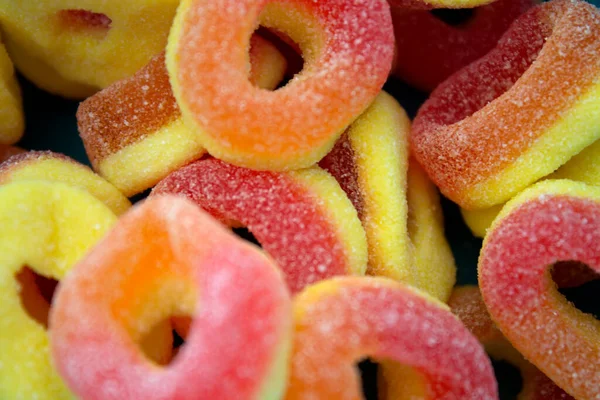 This is a photograph of sour peach candy rings