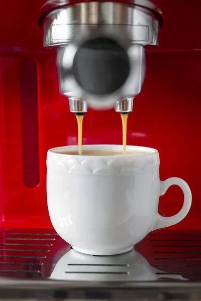 Pouring simple espresso with coffee machine. Closeup, selective focus