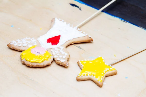 Ginger cookies decorated by a child during the master class of decorating ginger cakes with colored glaze. Christmas Treats. Handmade cookies. Closeup, selective focus