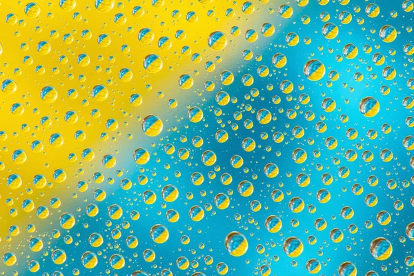 Water Drops Yellow Blue Background Top View Closeup — Stock Photo, Image