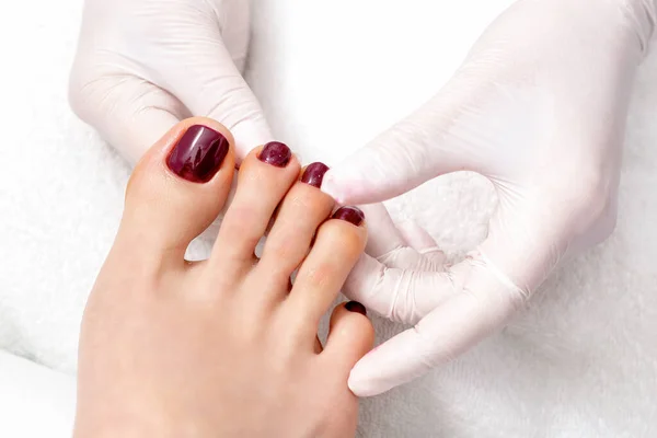 Top View Human Hands Protective Gloves Holding Woman Foot Painted — Stock Photo, Image