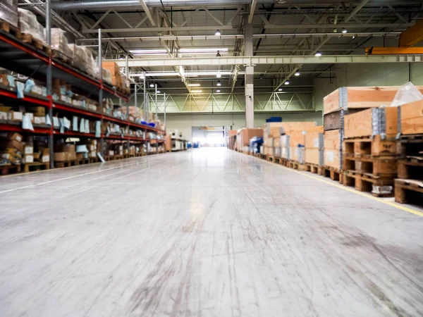 Warehouse industrial premises for storing materials and wood, there is a forklift for containers. Concept logistics, transport. Motion blur effect. Bright sunlight