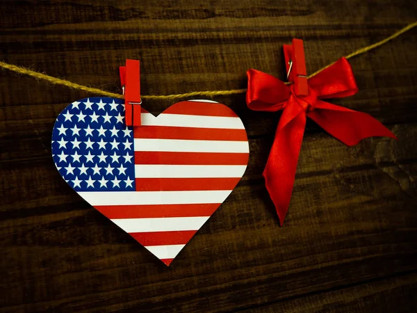 Flag of United States of America on heart shape with old vintage paper background, with clipping path - Independence Day.