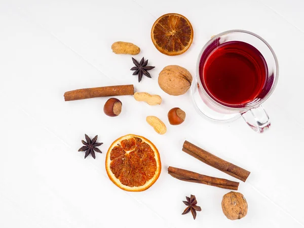 Glass of mulled wine and spices on white background — Stock Photo, Image