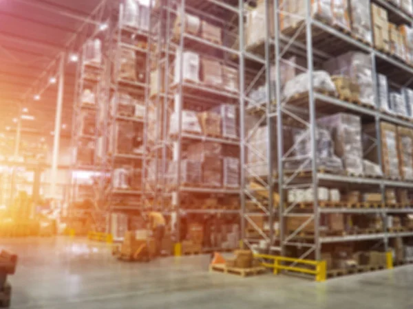 warehouse interior, Warehouse industrial and logistics companies. Commercial warehouse. Boxes and crates stocked on the shelves of three storey. The effect of motion blur. Bright sunlight.