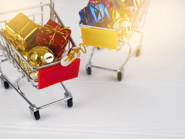 Christmas discount, Little shopping cart full of christmas gifts, Shopping trolley with gift boxes.