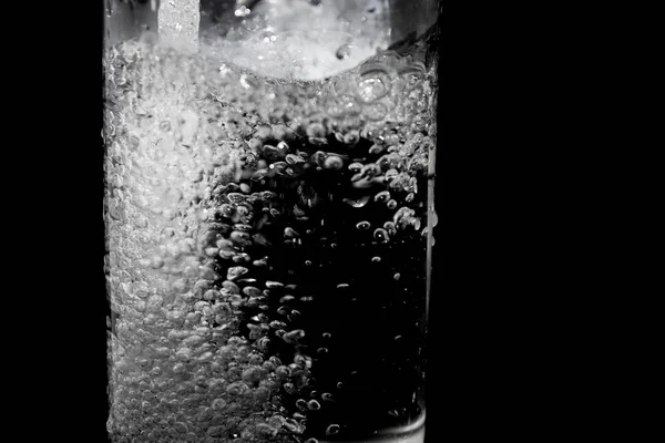 Splash of water on black, Stylish water splash. Isolated on black background, bubbles in the glass