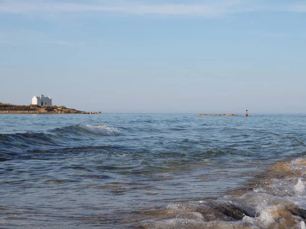 Beautiful greek summer sunny beach bay view to mediterranean blue sea awesome turquoise water like paradise with small white house village, Greece