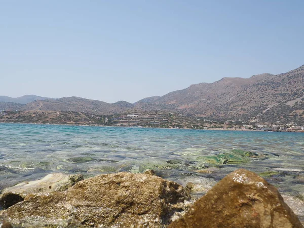 Beautiful greek summer sunny beach bay view to mediterranean blue sea awesome turquoise water like paradise with small white house village, Greece