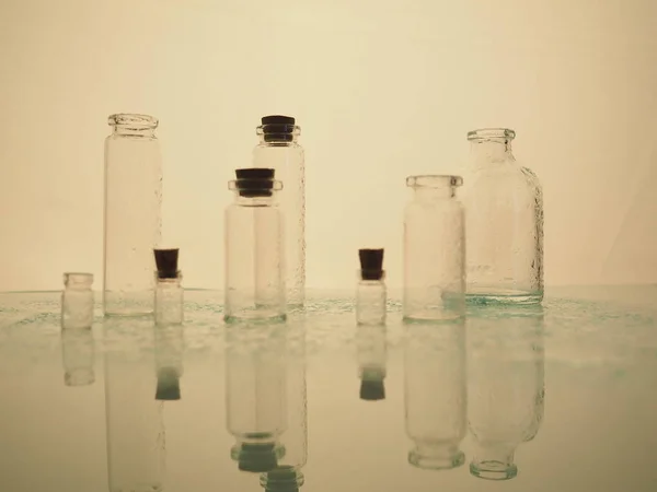 Трохи прозорих пляшок, розбризкування води. порожні скляні пляшки . — стокове фото