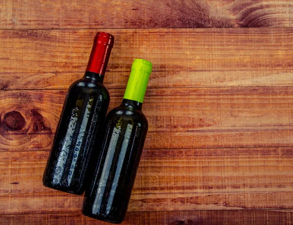 Two Bottles of Wine: Flat lay overhead shot of a bottle of blush wine on a wood table.