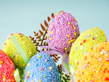 Mavi arkaplanda renkli Paskalya yumurtaları.