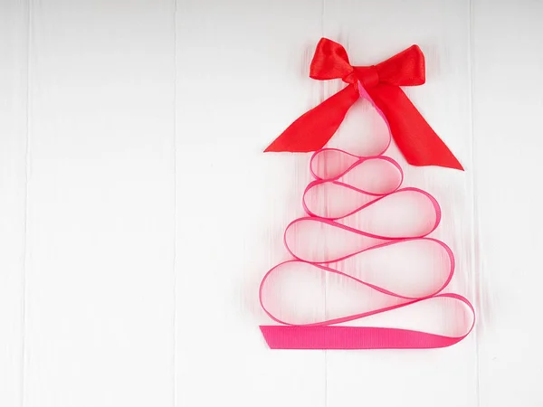 Kerstboom satijn roze lint, op witte achtergrond, kopie vriendelij — Stockfoto