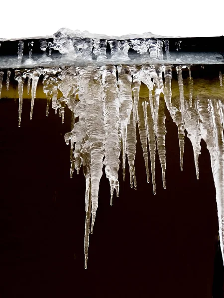 Ciclos e neve no telhado de perto. Conceito meteorológico de inverno. Congelado e fundo de gelo. Neve e gelo. A derreter ciclones. Ciclos e neve no telhado de perto. Inverno — Fotografia de Stock